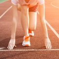 Athletic woman running on track
